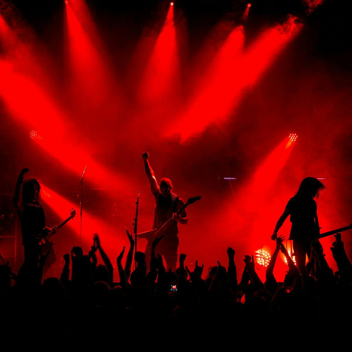 'Dead Congregation' perform on stage to an active crowd. Several red beams light up the scene.