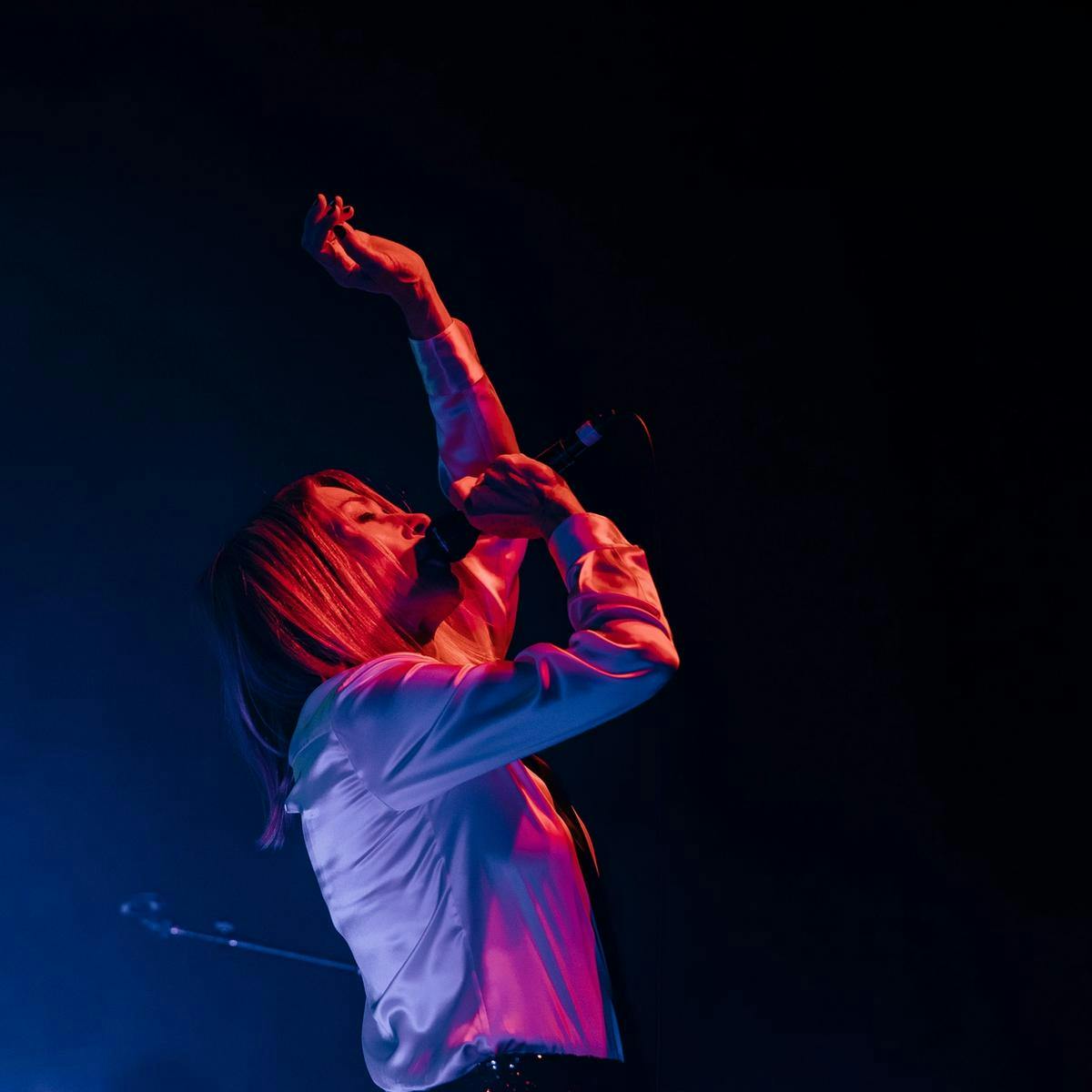 Kim Gordon performs on stage.